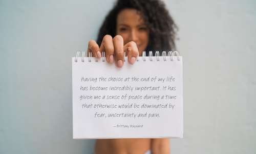 End_of_Life_Quote_in_Notebook_Held_By_Woman
