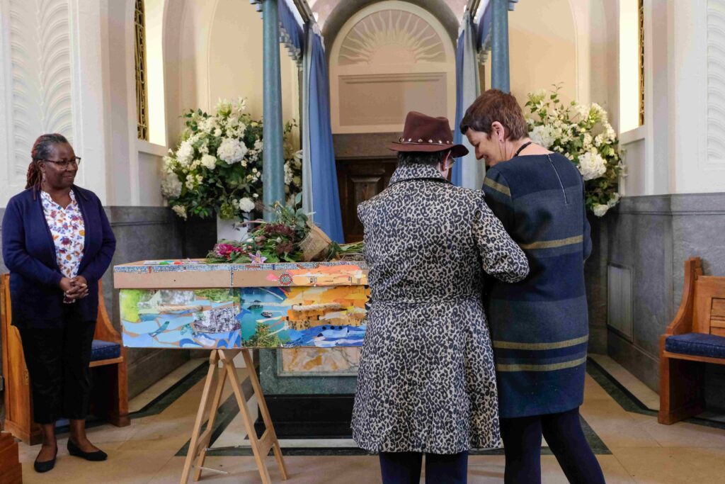 people paying their respects at a funeral